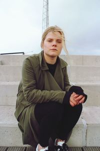 Portrait of a young man sitting outdoors
