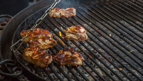 High angle view of meat on barbecue grill