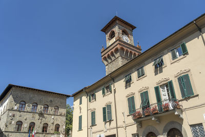 Low angle view of buildings against clear blue sky