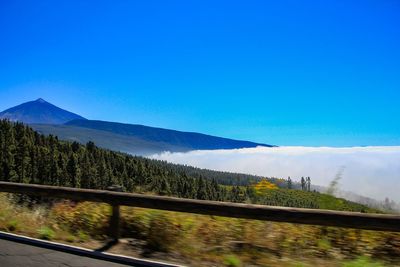 Scenic view of mountains against clear blue sky