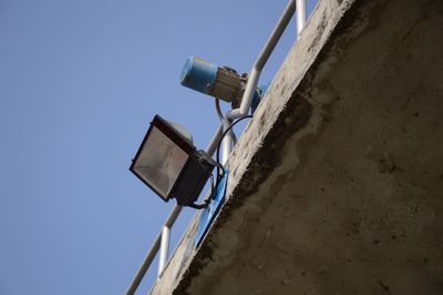 Low angle view of telephone pole against clear sky