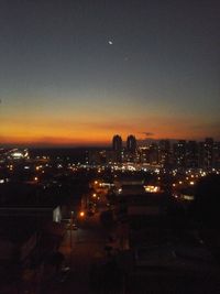 High angle view of illuminated buildings against sky at night