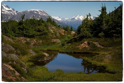 Scenic view of lake and mountains against sky