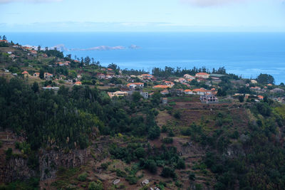 Panoramic view of townscape by sea against sky