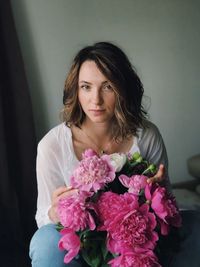 Portrait of woman with pink flower