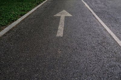 High angle view of arrow symbol on road