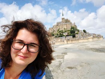 Portrait of woman against castle