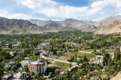 Panoramic view of city and mountains against sky