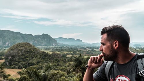 Portrait of young man against mountains