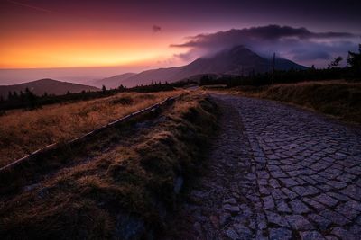 Scenic view of road against sky during sunset