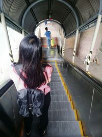 Rear view of woman in subway station