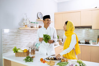 Man and woman standing on cutting board