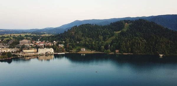 Scenic view of lake by buildings against sky