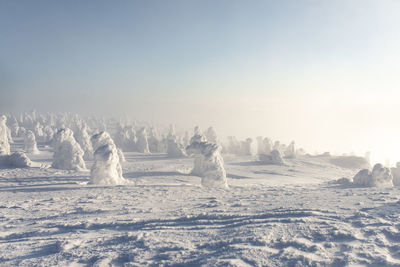 Scenic view of frozen landscape against sky