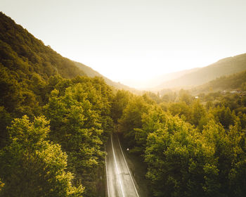 Road amidst mountains against clear sky