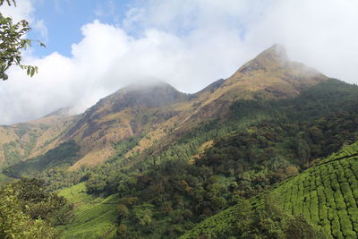 Scenic view of mountains against cloudy sky