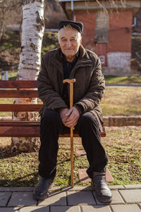 Portrait of man sitting on bench