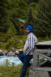 Rear view of man standing in forest