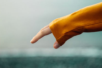 Close-up of hand holding yellow leaf