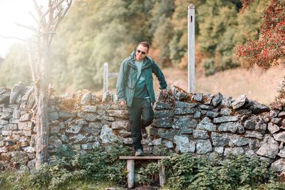 Portrait of man standing against wall