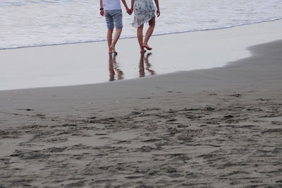 A couple walking on the beach.