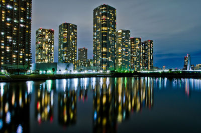 Reflection of illuminated buildings in city at night