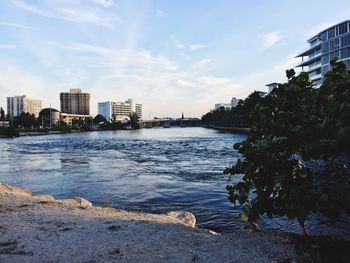 River amidst buildings against sky