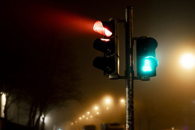 Low angle view of illuminated street light at night