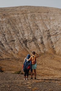 Rear view of couple on rock