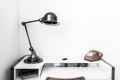 Close-up of electric lamp against wall