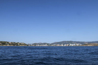 Scenic view of sea against clear blue sky