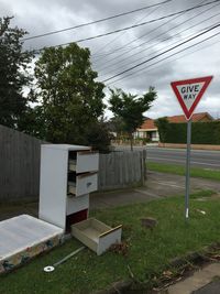 Road sign against sky
