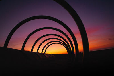 Silhouette landscape against sky during sunset