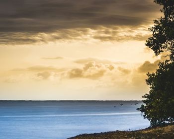 Scenic view of sea against sky at sunset