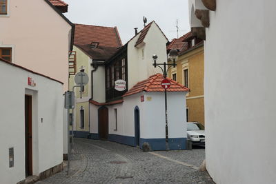 Houses by street in town against sky