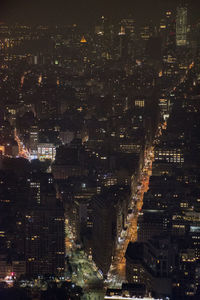 Aerial view of city lit up at night