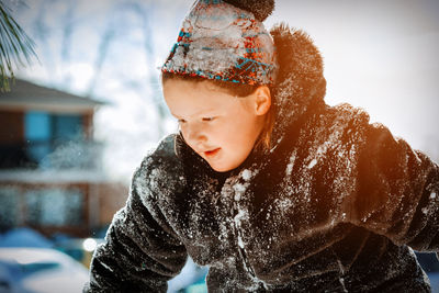 Portrait of boy looking at snow