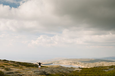 Scenic view of mountains against cloudy sky