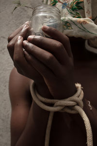 Cropped hand of woman holding rope