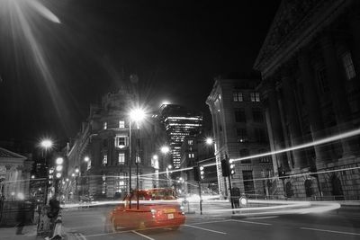 Illuminated city street at night