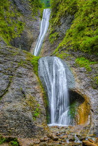 Scenic view of waterfall against sky