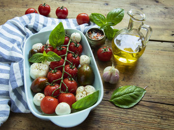 Fresh vegetable tomato, basil, mozzarella cheese for baking in the oven in ceramic dishes. cooking