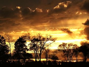 Silhouette of landscape against cloudy sky