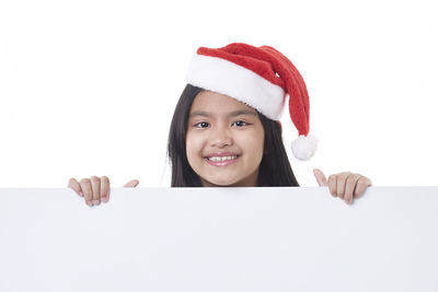 Portrait of a smiling young woman against white background