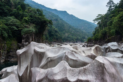 Naturally formed white shiny stone in unique shape at dry river bed at morning from flat angle