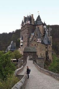 Man walking in front of historic building