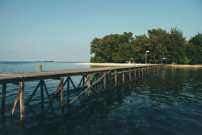 Pier over sea against clear sky