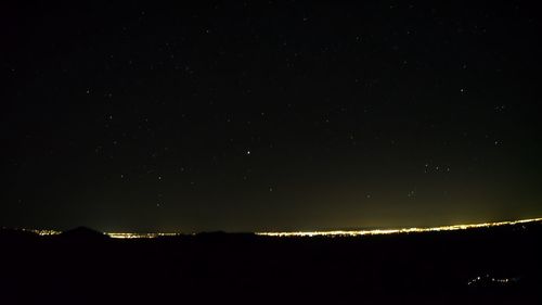 Scenic view of silhouette mountain against sky at night