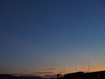 Low angle view of silhouette building against sky at sunset