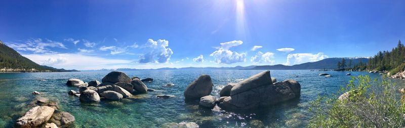 Panoramic view of sea against blue sky